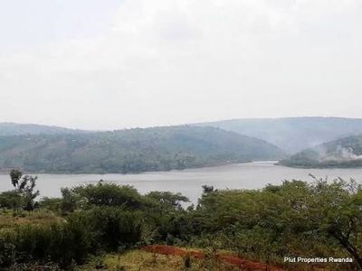 Split view comparing vacant land and a finished house for sale in Kigali, Rwanda