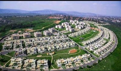 Family deciding between buying land to build or buying a finished house in Rwanda